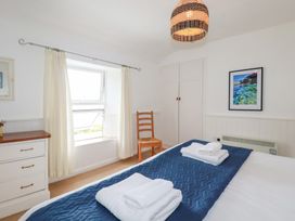 A bedroom with a bed and dresser at Nanvivian in Feock near Truro