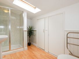 A bathroom with shower, sink, and plant at Nanvivian in Feock near Truro