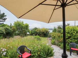 An outdoor garden with chairs and an umbrella at Nanvivian in Feock near Truro