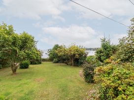 A garden with trees and grass at Nanvivian in Feock near Truro