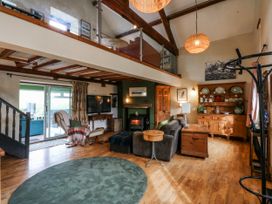 A living room with a sofa and coffee table at Pen Glorian, Conwy