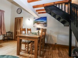 A dining room with a table and chairs at Pen Glorian in Conwy