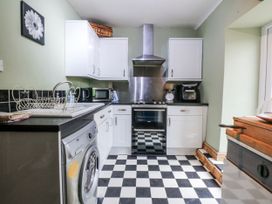 A kitchen with appliances and cabinets at Pen Glorian in Conwy
