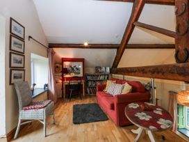 A snug with a sofa and desk at Pen Glorian in Conwy