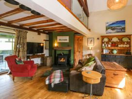 A living room with a fireplace and sofa at Pen Glorian in Conwy