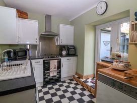 A kitchen with appliances and cabinets at Pen Glorian in Conwy