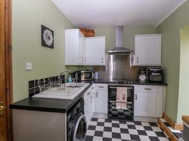 A kitchen with appliances and cabinets at Pen Glorian in Conwy