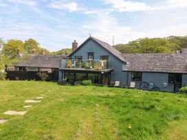 A house with a balcony and garden area at Pen Glorian in Conwy