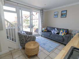 A living room with a sofa and armchair at Sea Spray in Bowleaze
