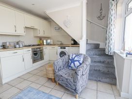 A kitchen with counter and appliances at Sea Spray in Bowleaze