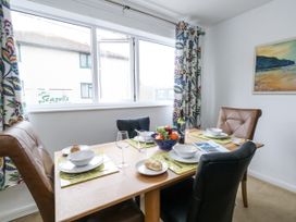 A dining room with a table set for four at Flat 13, Chesil House in Bridport