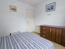 A bedroom with a bed and chest of drawers at Beachcombers, 13 Chesil House Bridport
