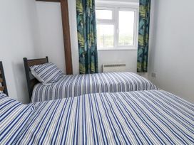 A bedroom with two beds and a window at Beachcombers, 13 Chesil House in Bridport