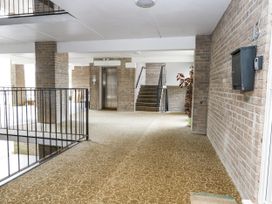 A hallway with an elevator and stairs at Beachcombers, 13 Chesil House in Bridport