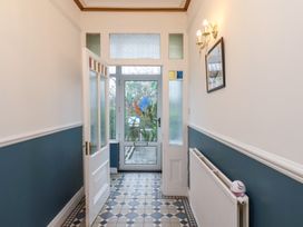 A hallway with a door and window at Kingfisher House Saltburn-by-the-Sea