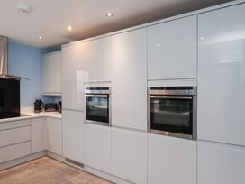 A kitchen with built-in ovens and a stovetop at Kingfisher House in Saltburn-by-the-Sea
