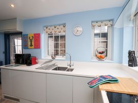 A kitchen with sink and utensils at Kingfisher House Saltburn-by-the-Sea
