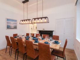 A dining room with a large table and chairs at Kingfisher House Saltburn-by-the-Sea