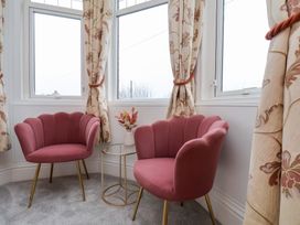 A snug area with two armchairs and a table at Kingfisher House in Saltburn-by-the-Sea