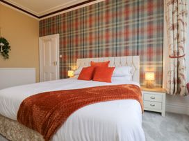A bedroom with a bed and nightstand at Kingfisher House in Saltburn-by-the-Sea