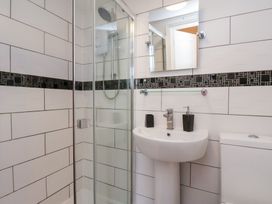 A bathroom with a shower, sink, and toilet at Kingfisher House in Saltburn-by-the-Sea