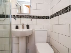 A bathroom with a sink, toilet and shower at Kingfisher House Saltburn-by-the-Sea