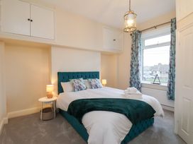 A bedroom with a bed and bedside table at Kingfisher House in Saltburn-by-the-Sea