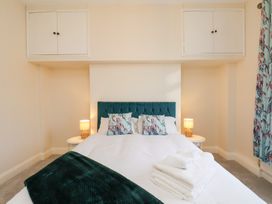 A bedroom with a bed and lamp at Kingfisher House Saltburn-by-the-Sea
