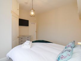 A bedroom with a bed and a TV at Kingfisher House Saltburn-by-the-Sea