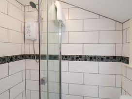 A bathroom with a shower and water heater at Kingfisher House in Saltburn-by-the-Sea