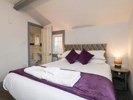 A bedroom with a bed and bedside table at Kingfisher House Saltburn-by-the-Sea