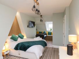 A bedroom with a bed and television at Kingfisher House in Saltburn-by-the-Sea