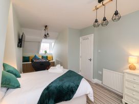 A bedroom with a bed and a foosball table at Kingfisher House Saltburn-by-the-Sea