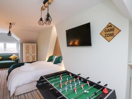 A bedroom with a foosball table and television at Kingfisher House in Saltburn-by-the-Sea