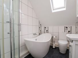 A bathroom with a bathtub, shower and toilet at Kingfisher House in Saltburn-by-the-Sea