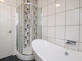 A bathroom with a shower and bathtub at Kingfisher House Saltburn-by-the-Sea