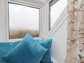 A snug area with cushions and a window view at Kingfisher House Saltburn-by-the-Sea