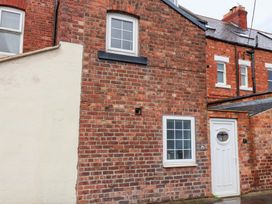 An exterior view of a brick house with windows and a door at Kingfisher House in Saltburn-by-the-Sea