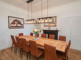A dining room with a wooden table and chairs at Kingfisher House in Staithes