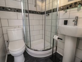 A bathroom with a shower, toilet, and sink at Kingfisher House in Staithes