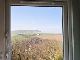 A view from a window showing fields and hills at Kingfisher House in Staithes