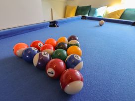 A pool table with billiard balls arranged at Kingfisher House in Staithes