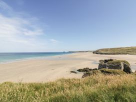 A beach with sand and rocks at The Old Piggery in Porthtowan, Near St Agnes