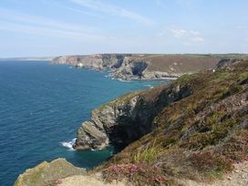 A coastal view with cliffs and ocean at The Old Piggery in Porthtowan, Near St Agnes