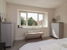 A bedroom with dressers and a window at St Gregory’s Cottage in Oswaldkirk near Helmsley