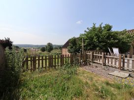 A garden with a fenced area and deck chairs at St Gregory’s Cottage Oswaldkirk near Helmsley