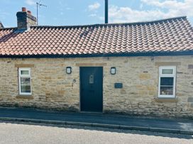 A cottage exterior with a door and windows at St Gregory’s Cottage in Oswaldkirk near Helmsley