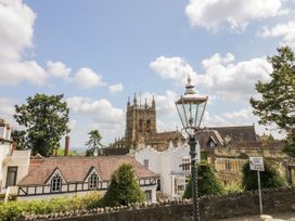 A town view with old buildings trees a lamp post and a church tower at Elmside Lodge in Welland Malvern