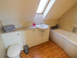 A bathroom with a bathtub toilet sink and countertop with towels and soap at Little Barn in Dodwell near Stratford-Upon-Avon