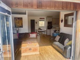 A living room with a coffee table and sofas at Woodburn Lodge in Otterburn
